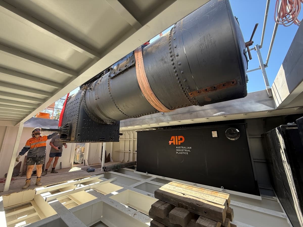 PS Australian Star’s engine being guided into place by a tradesperson