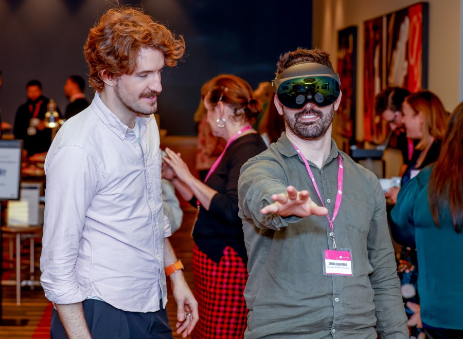 Two men with one man wearing virual reality headset.